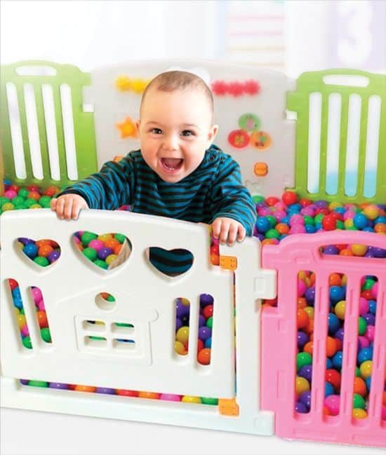 Child playing in a play pen